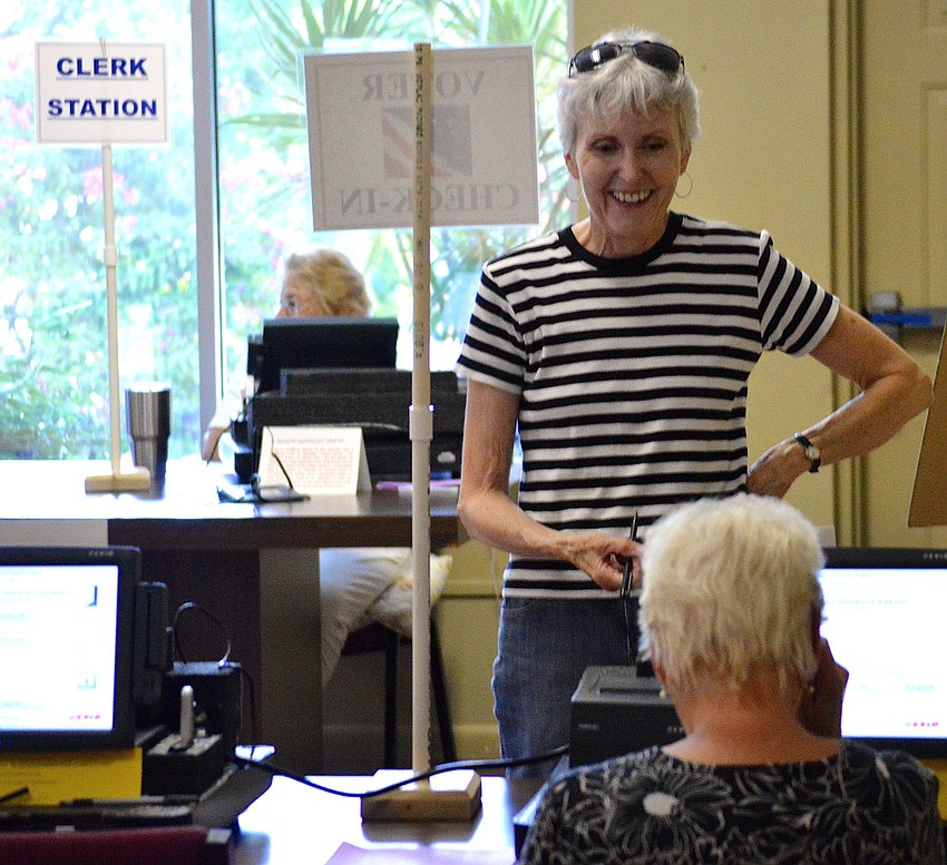 Janet Andres, a Manatee County resident from Longboat Key, casts her vote at the Longboat Island Chapel Tuesday morning.