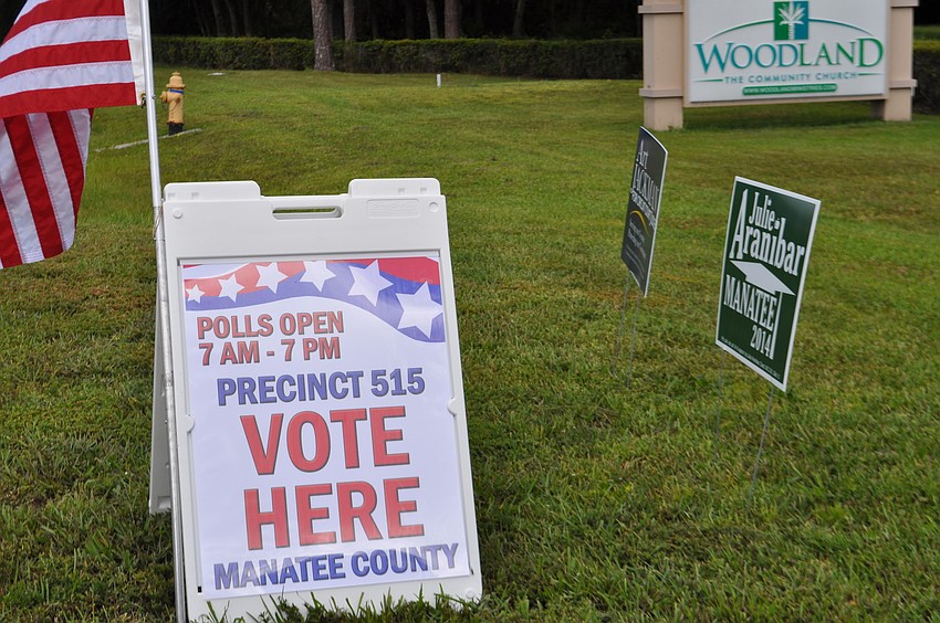 Signs dot the parking lot at Woodland Community Church, in East County.