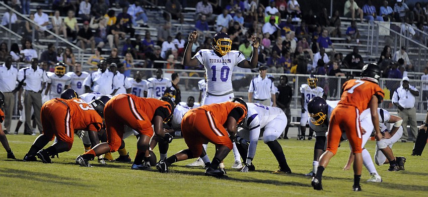 Booker senior quarterback Jeremiah Henderson calls the play at the line of scrimmage.