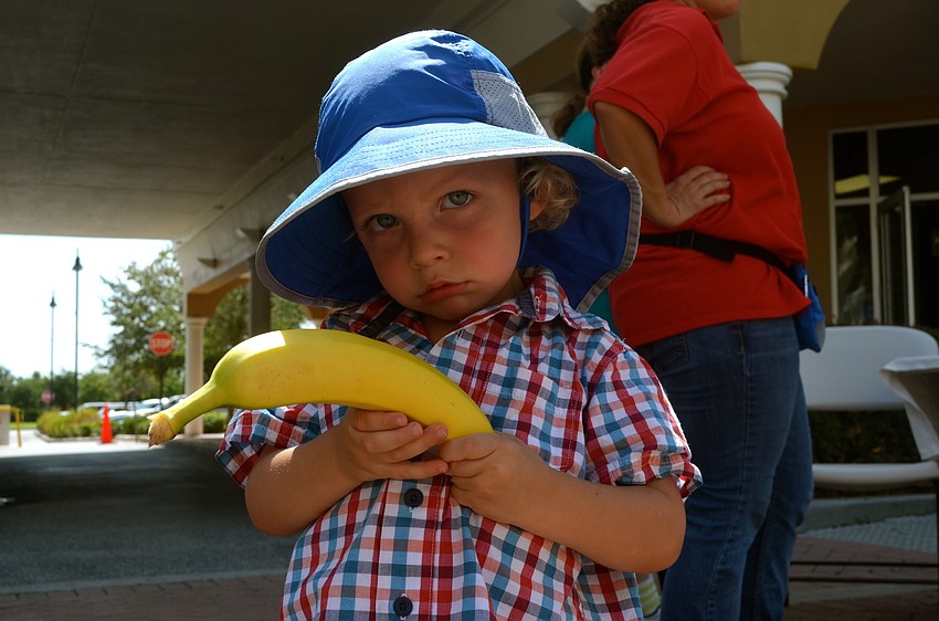 Luca Milbank picks out a piece of fruit.