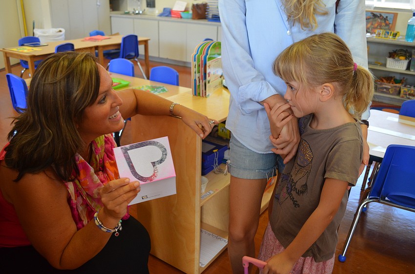 Teacher Ashlyn Dobson accepts a card from incoming student, Ella C.