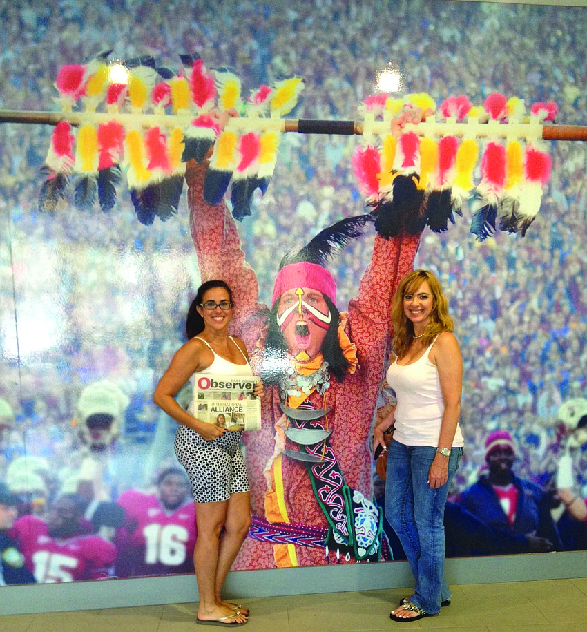 FAMILY FUN. Nuris Fanning and Karmen McGill brought their Observer along while attending the graduation ceremony for McGillâ€™s daughter, Megan (not pictured), from Florida State University in Tallahassee.