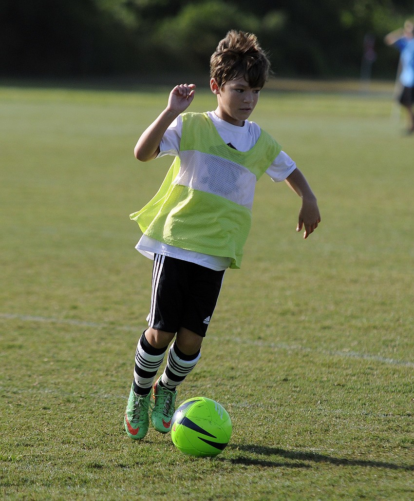 Ten-year-old Bin Espiritu warms up before his team takes the field.