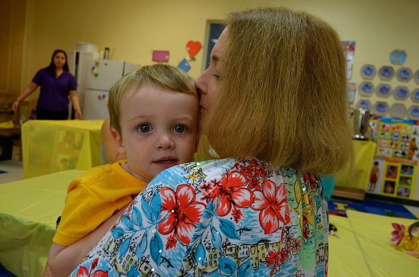 Louis Mahiquez cuddles with his grandmother, Pamela Hood.