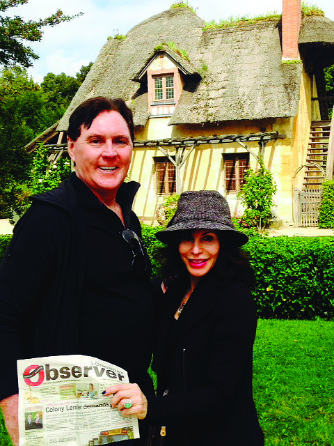 FRENCH CONNECTION. Bernard and Lauren Walsh enjoyed catching up on their Longboat Observer news while touring Marie Antoinette's estate on the grounds of the Palace of Versailles. The Walshes also enjoyed sightseeing in Paris.