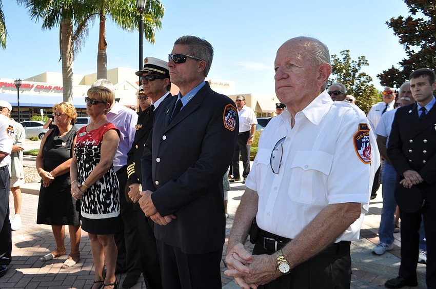 Retired New York firefighter Don O'Leary, right, watches the ceremony.