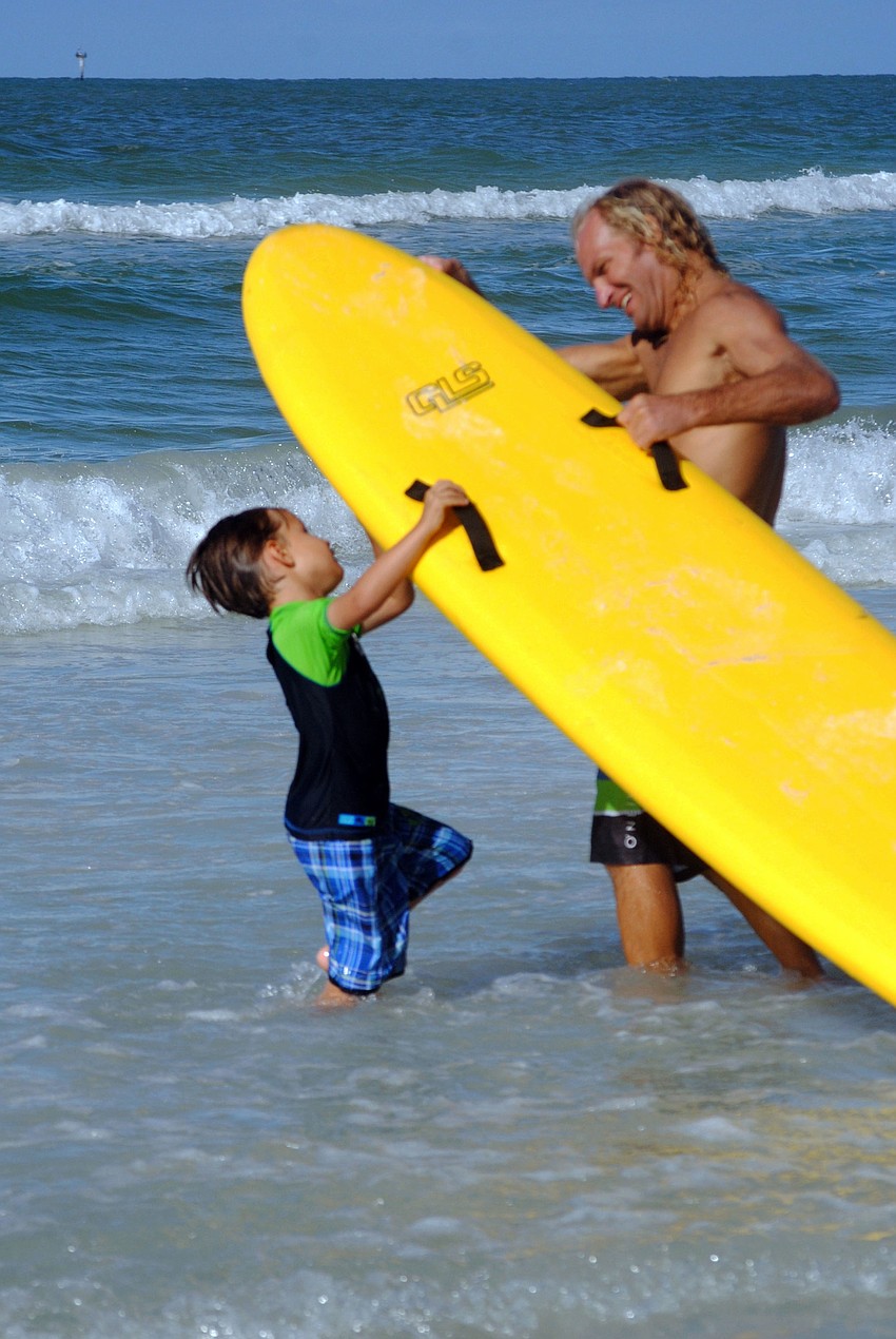 Gabrielle Bishop heads out to the water with a volunteer.