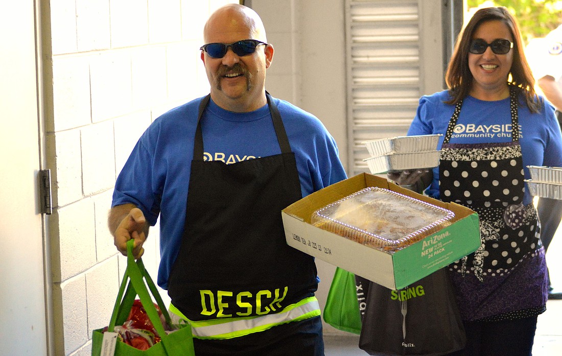 Firefighter/paramedic Brandon and Rebecca Desch deliver food Thursday with Bayside Community Church's annual 9/11 outreach program. Since 2008, the church has provided lunch for first responders on Sept. 11. Photo by Caleb Motsinger
