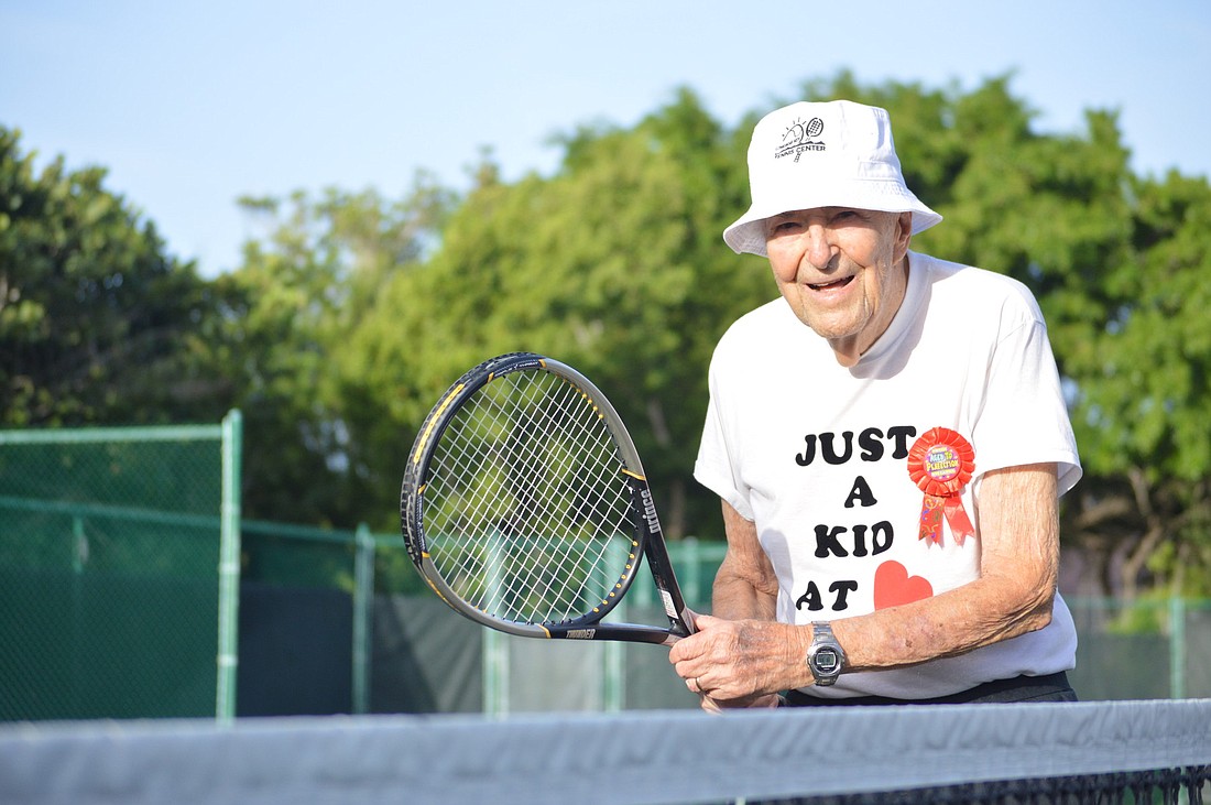 Plymouth Harbor resident George Heitler turned 99 on Sept. 3, but his shirt says he's still "Just a kid at heart." He still plays tennis three days a week. Photo by Caleb Motsinger
