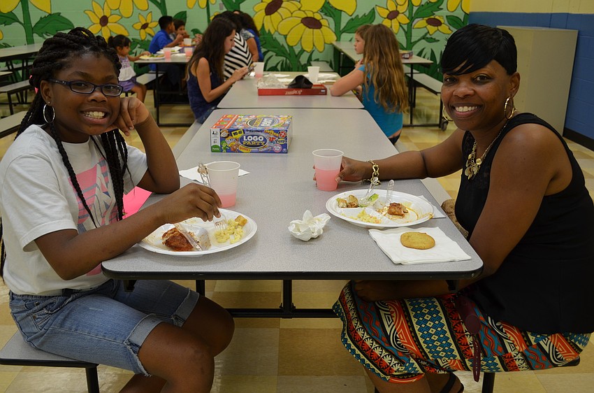 Janyla, 11, and her mother Cleshia Woodie enjoy dinner at the CYD Family Fun Night.