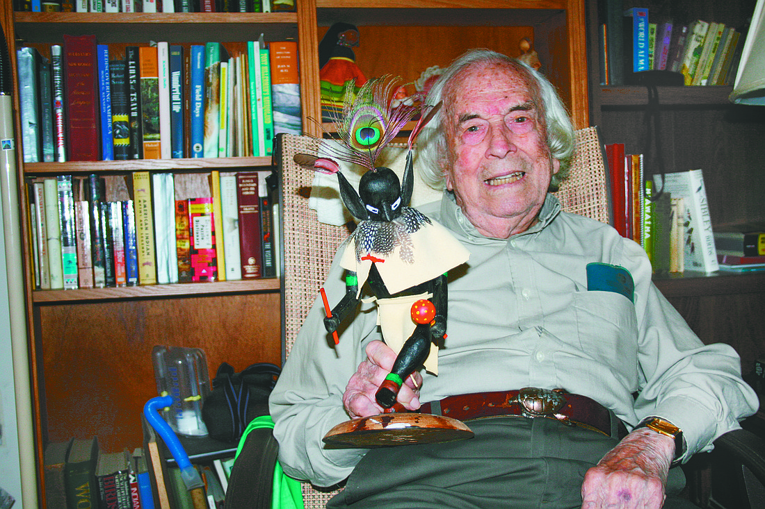 Orville Clayton, pictured in 2009, at Westminster Manor in Bradenton, holding one of his recent woodcarvings, a Kachina doll. His belt buckle features a turtle. File photo