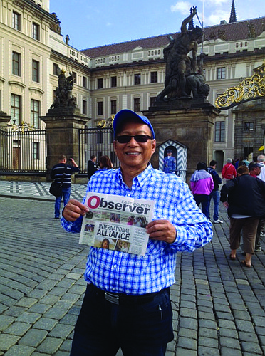 CZECH MARK. East County resident Fred Lopez reads his East County Observer in front of the Prague Castle, the official residence of the president of the Czech Republic.