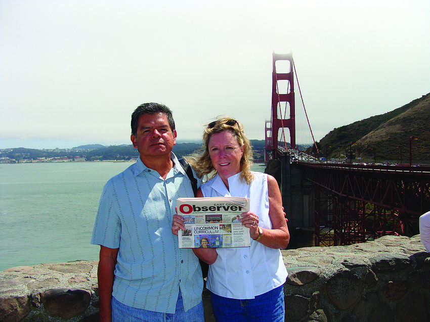 GOLDEN HOUR. Pete and Martha Mirande catch up on their Observer news while visiting family and friends in San Francisco.