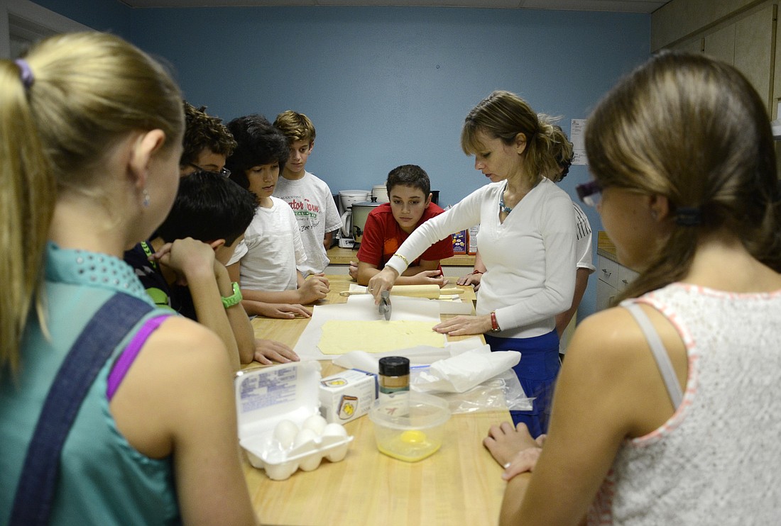 Temple Emanu-El teacher Lesley Lempel teaches the sixth-grade religion class how to make chocolate rogulach.