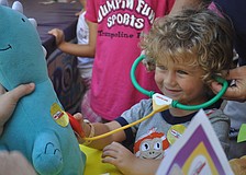 Hunter Montague listens to the heartbeat of his stuffed friend â€” Dinorex.