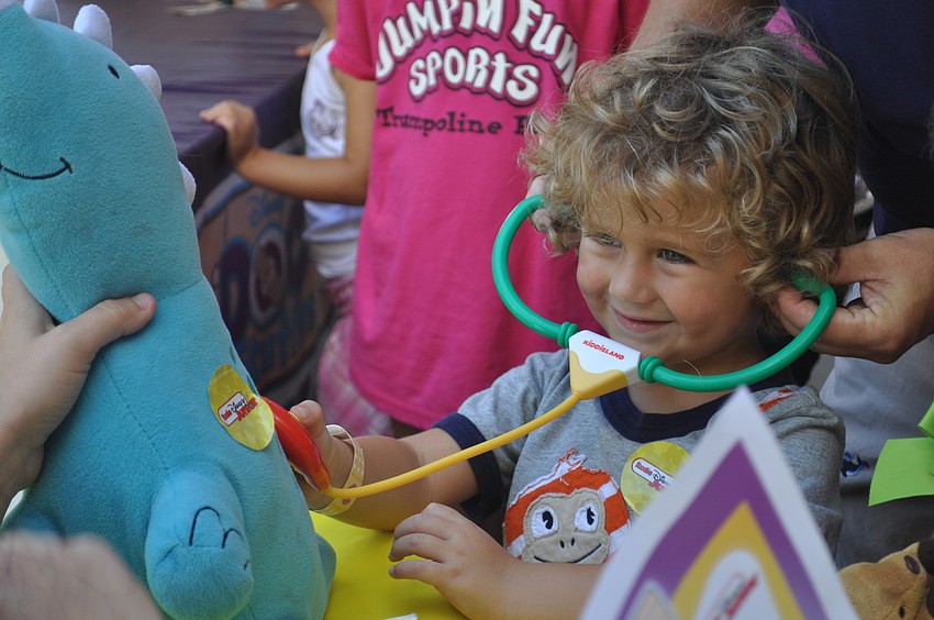 Hunter Montague listens to the heartbeat of his stuffed friend â€” Dinorex.