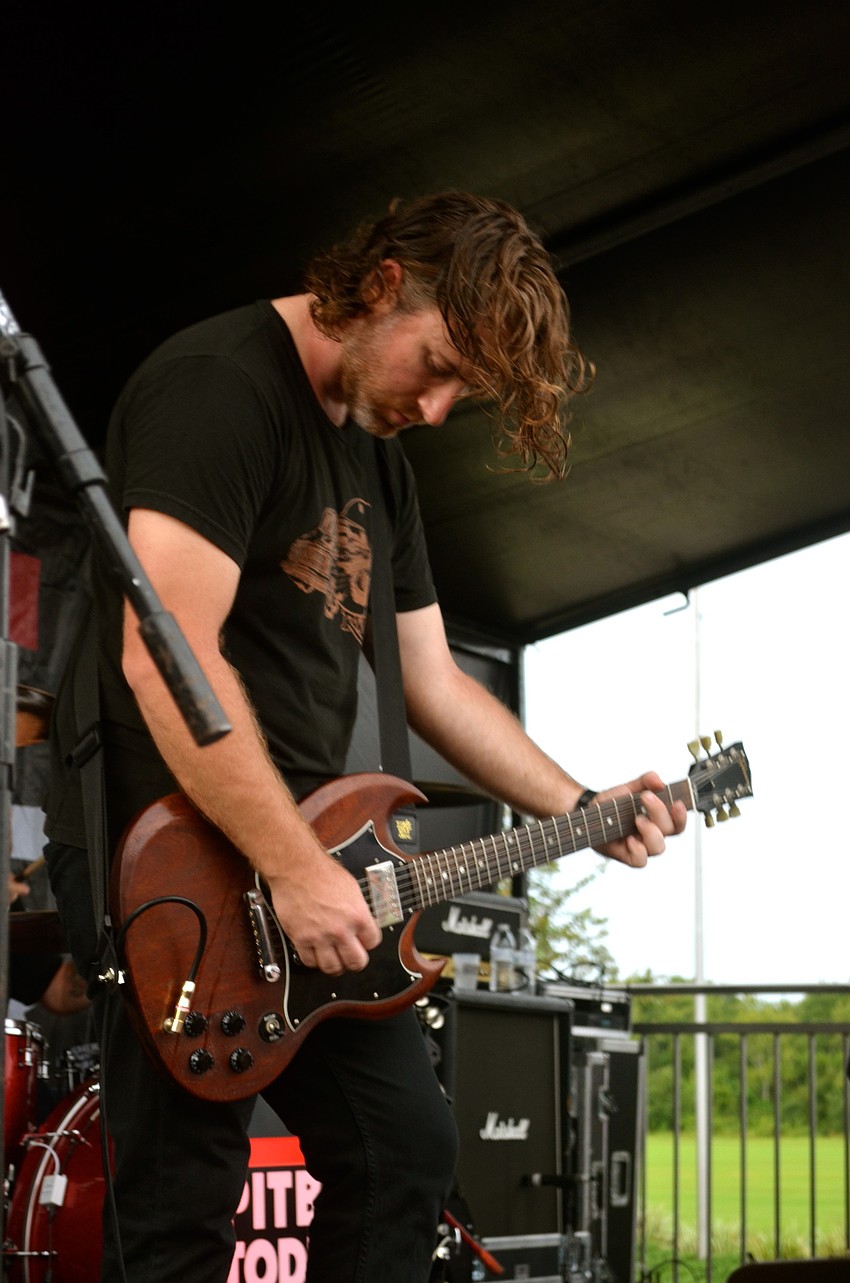 John Brennan plays the guitar during Pitbull Toddler's performance.