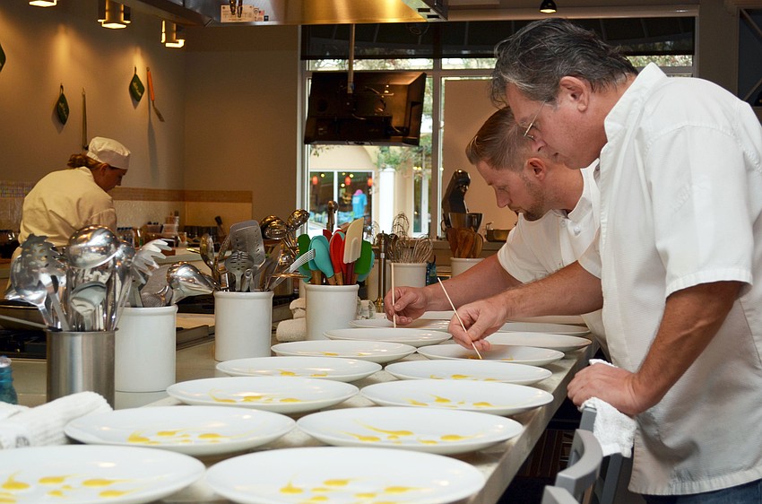 Chef Jose Martinez and USFSM Hospitality students prepare food for the Maison Blanche Farm to Food dinner.