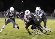 Braden River defenders Demetrius Lawson, JoJo Louis and Jimiah Albritton tackle Sarasota wide receiver Dakota Cotner in the first half.