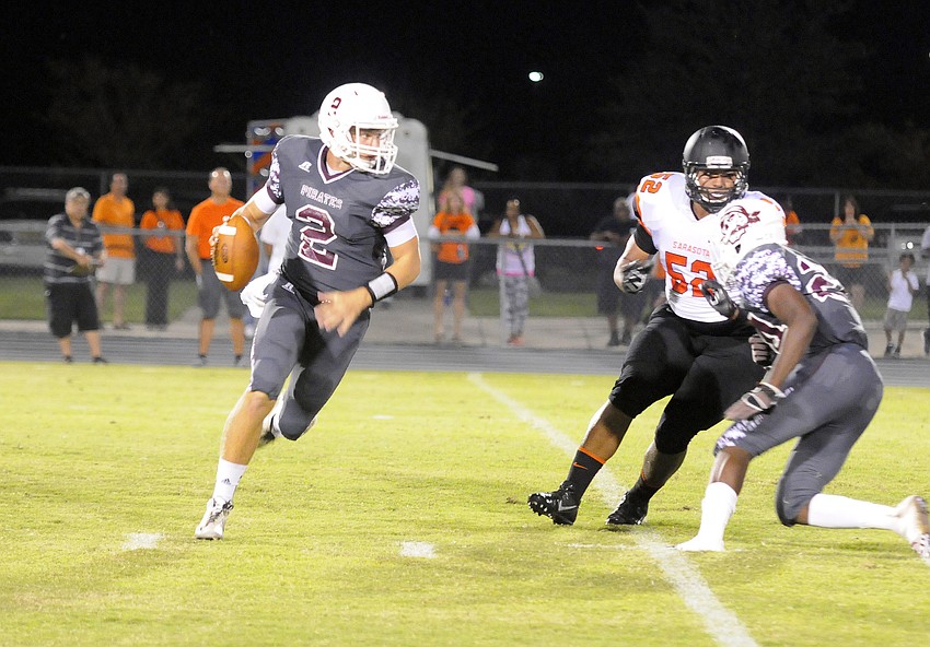 Braden River quarterback Jacob Huesman rolls out of the pocket in the first half.