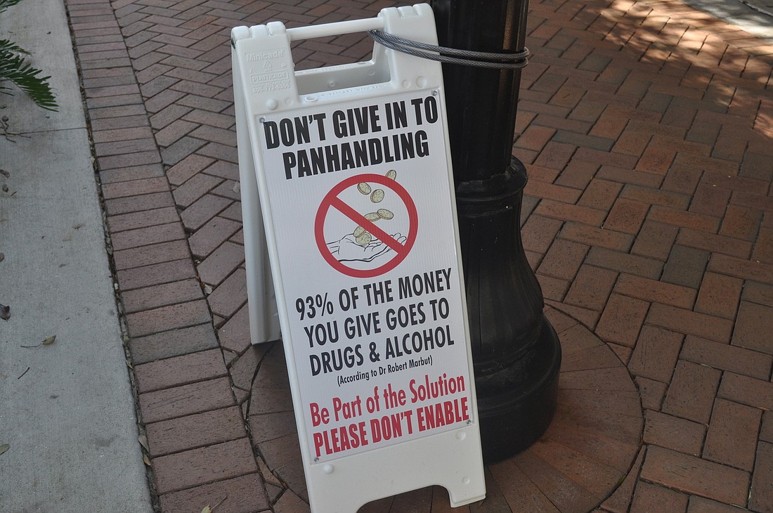 A sign on Main Street discourages donations to panhandlers. As part of a new campaign, downtown merchants will offer donation boxes, with funds going to homelessness serves providers.
