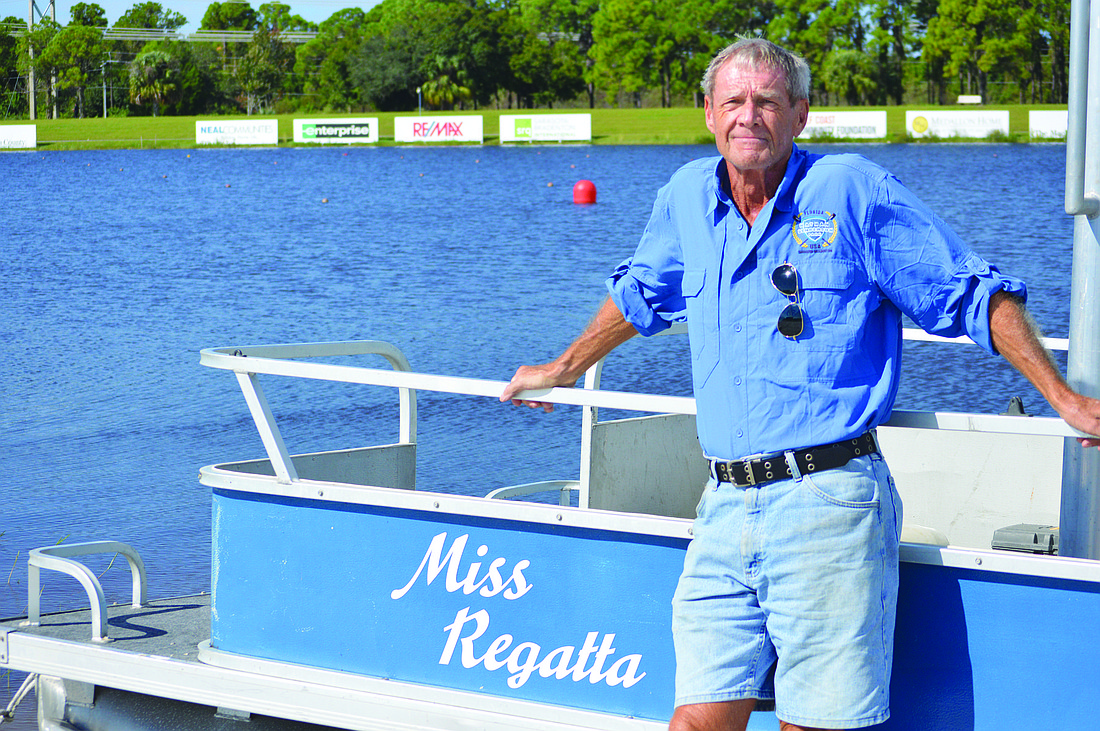 Bill Johnson, 70, stands by the boat he uses while volunteering at rowing races for Suncoast Aquatic Nature Center Associates (SANCA) events at Nathan Benderson Park. Photo by Caleb Motsigner