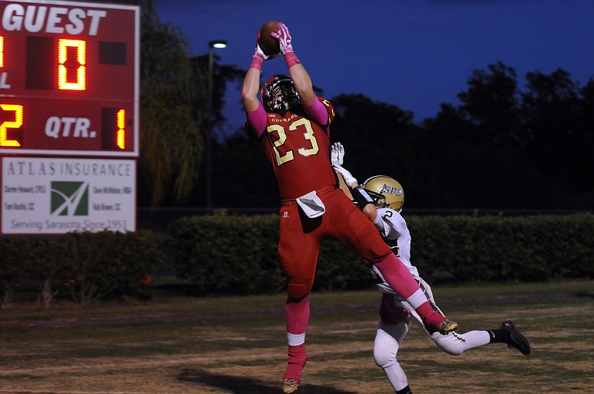 Cardinal Mooney tight end Mitch Arimura caught a 13-yard touchdown pass in the first quarter of the Cougars 49-7 victory over St. Pete Catholic.