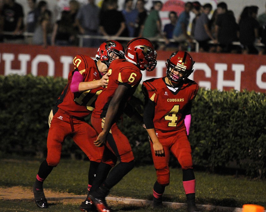 Mike Garris and Sean Morris celebrate with T. Hebda following Hebdaâ€™s punt return for a touchdown in the fourth quarter, which was ultimately called back by a penalty.