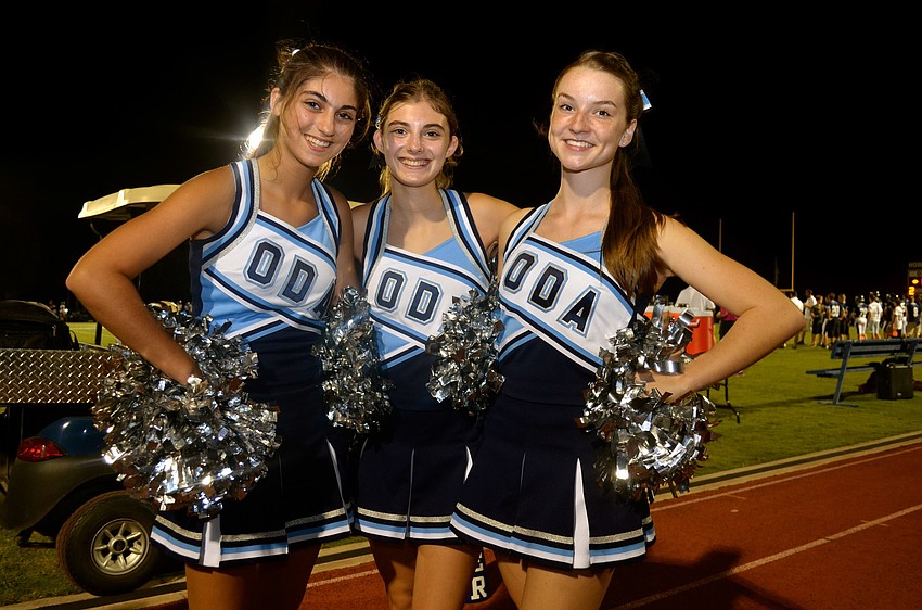 Varsity cheerleaders Alexa and Ashley Debartolo pose with Anne Keen.