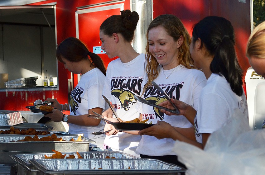 Members of the Cardinal Mooney swim team helped serve guests at the Homecoming Fish Fry.