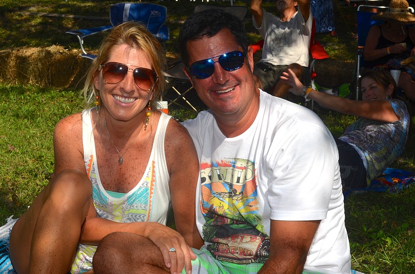 Eileen and Scott Lubore find a spot in the shade to listen to live music.
