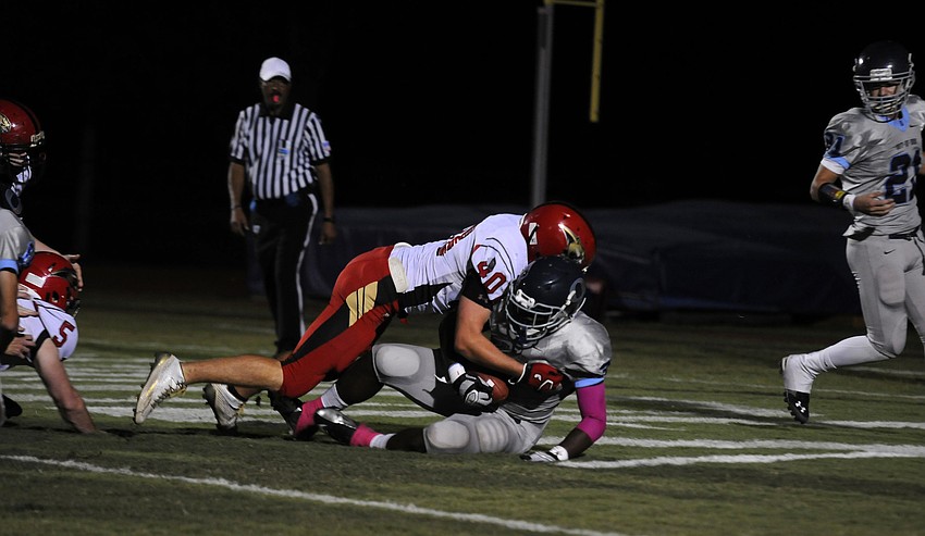 Cardinal Mooney linebacker Sam Leonard tackles ODA running back Najee Rhodes in the end zone for a safety.
