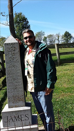 Hunter Norton takes a picture at the grave of Jesse James, on the JamesÃ¢â‚¬â„¢ Family Farm in Missouri.