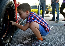 Colin Robinson inspects a race car tire.