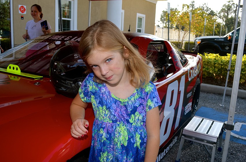 Allison Rothhaar is excited about being near a race car.