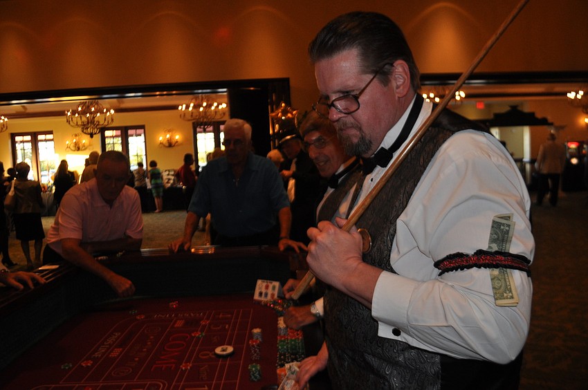 George Conover leads guests in a game of craps.