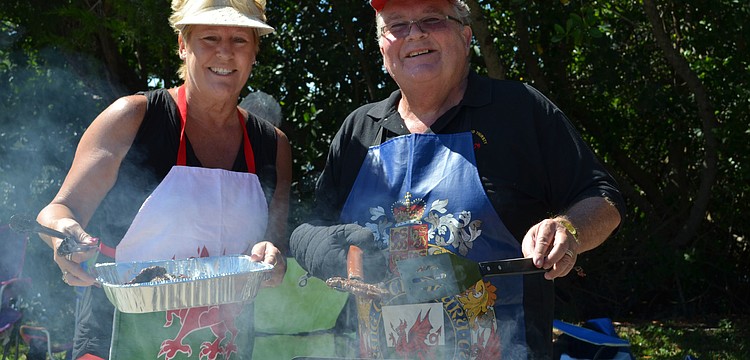 Sandra and David Rees serve up hotdogs and hamburgers at the Welsh Society picnic.