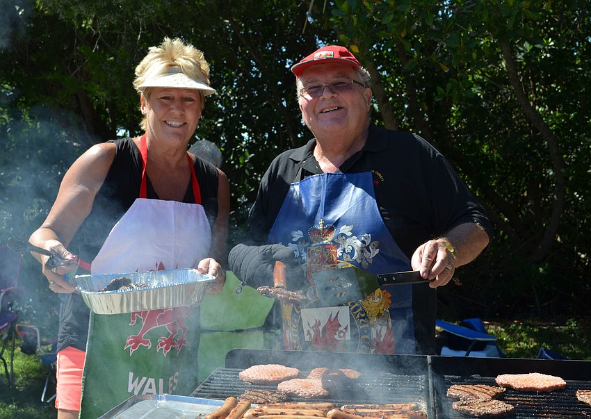 Sandra and David Rees serve up hotdogs and hamburgers at the Welsh Society picnic.