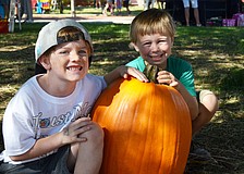 Ryan Harper and Ryland Sands take home a large pumpkin from the Sarasota Pumpkin Festival.