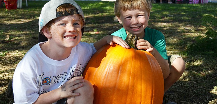Ryan Harper and Ryland Sands take home a large pumpkin from the Sarasota Pumpkin Festival.