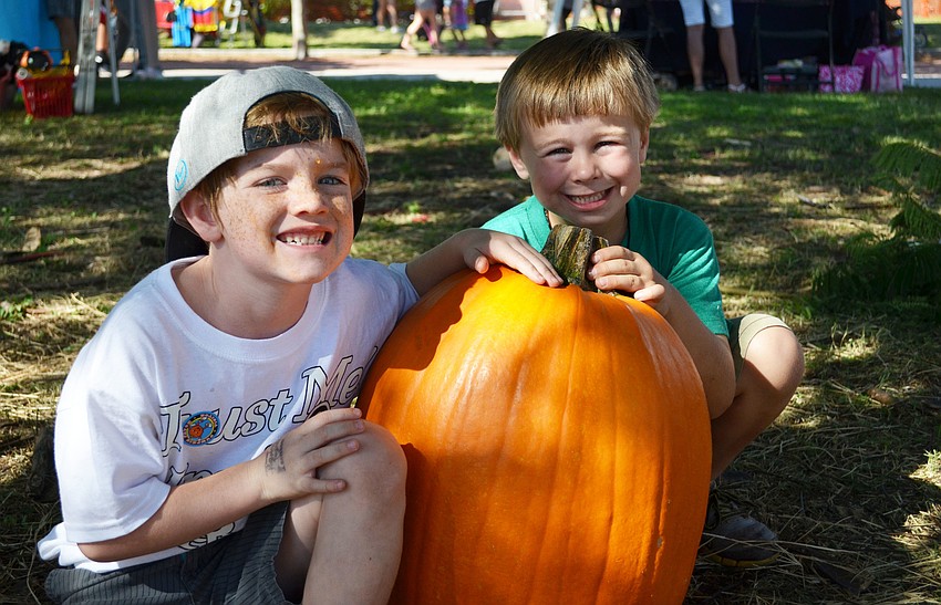 Ryan Harper and Ryland Sands take home a large pumpkin from the Sarasota Pumpkin Festival.