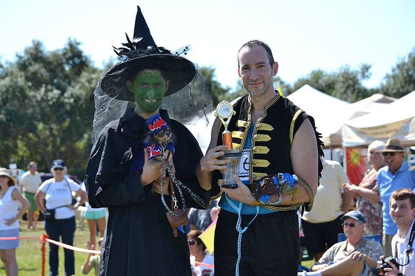 Alex Breslin dressed as the Wicked Witch of the West from the Wizard of Oz, holds Java Chip who is dressed as a flying monkey. Dan Plonsky is dressed as a flying monkey as well and is holding Danny, a squirrel monkey.