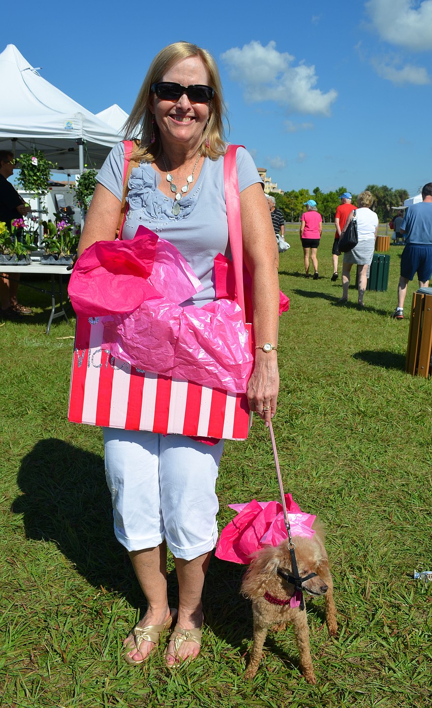 Beth Leslie matches her miniature poodle Taffie dressed as a Victoriaâ€™s Secret shopping bag.