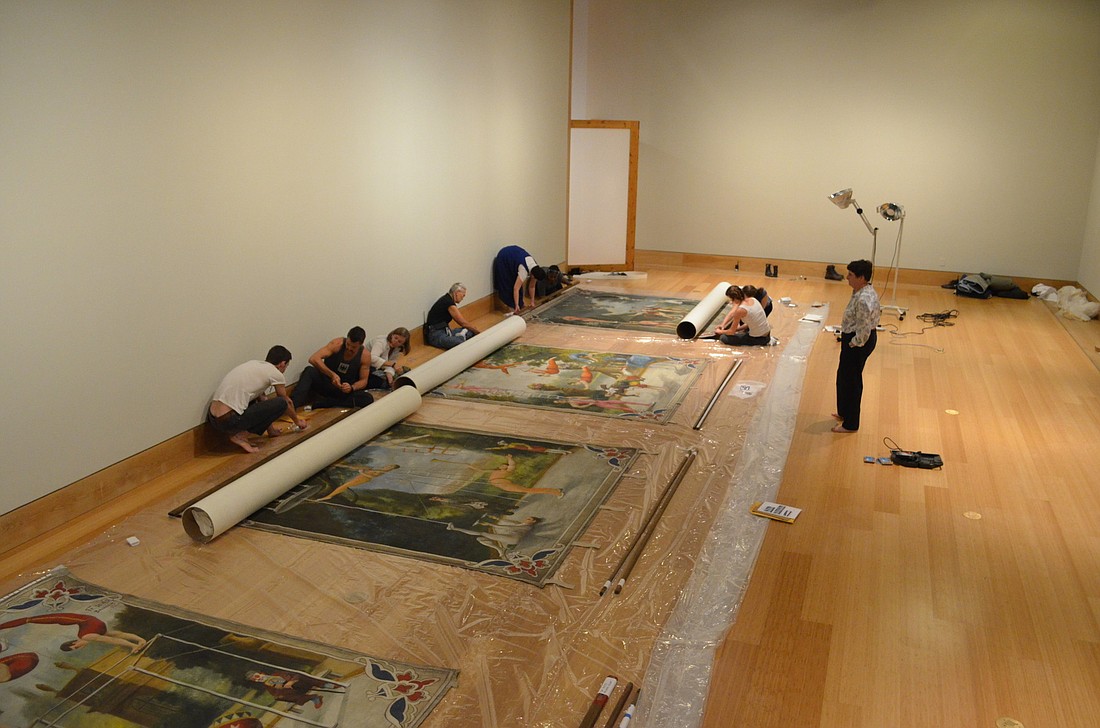 The restoration volunteers and museum staff add final touches to the four banners.