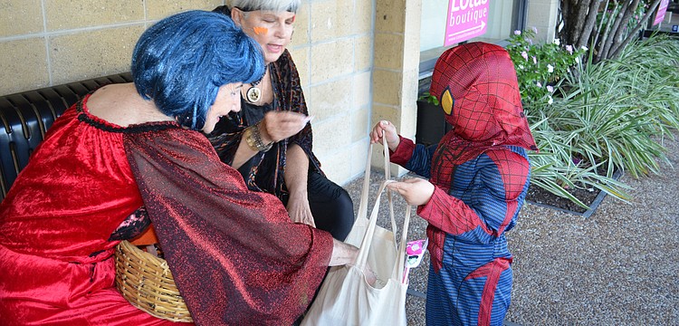 Merchants handed out candy to trick-or-treaters in Siesta Key Village.