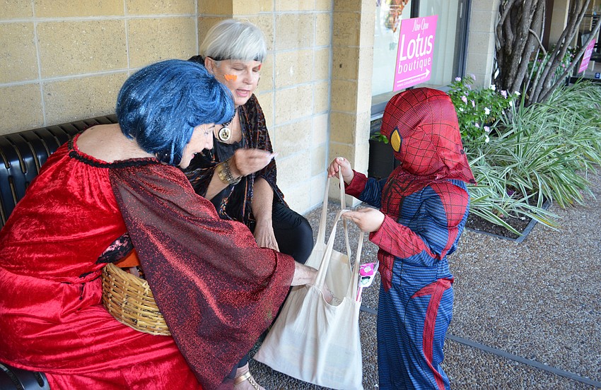 Merchants handed out candy to trick-or-treaters in Siesta Key Village.