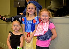 Sisters Julianne, Reagan and Shannon Mathews play dress up.
