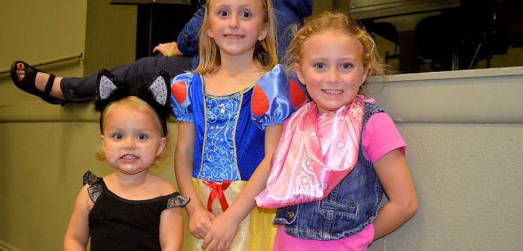 Sisters Julianne, Reagan and Shannon Mathews play dress up.