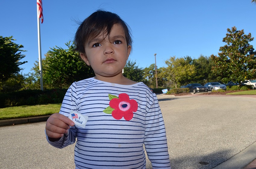 Sophie Kulatilaka-Rivers accompanies her mother, Ishani, on Election Day.