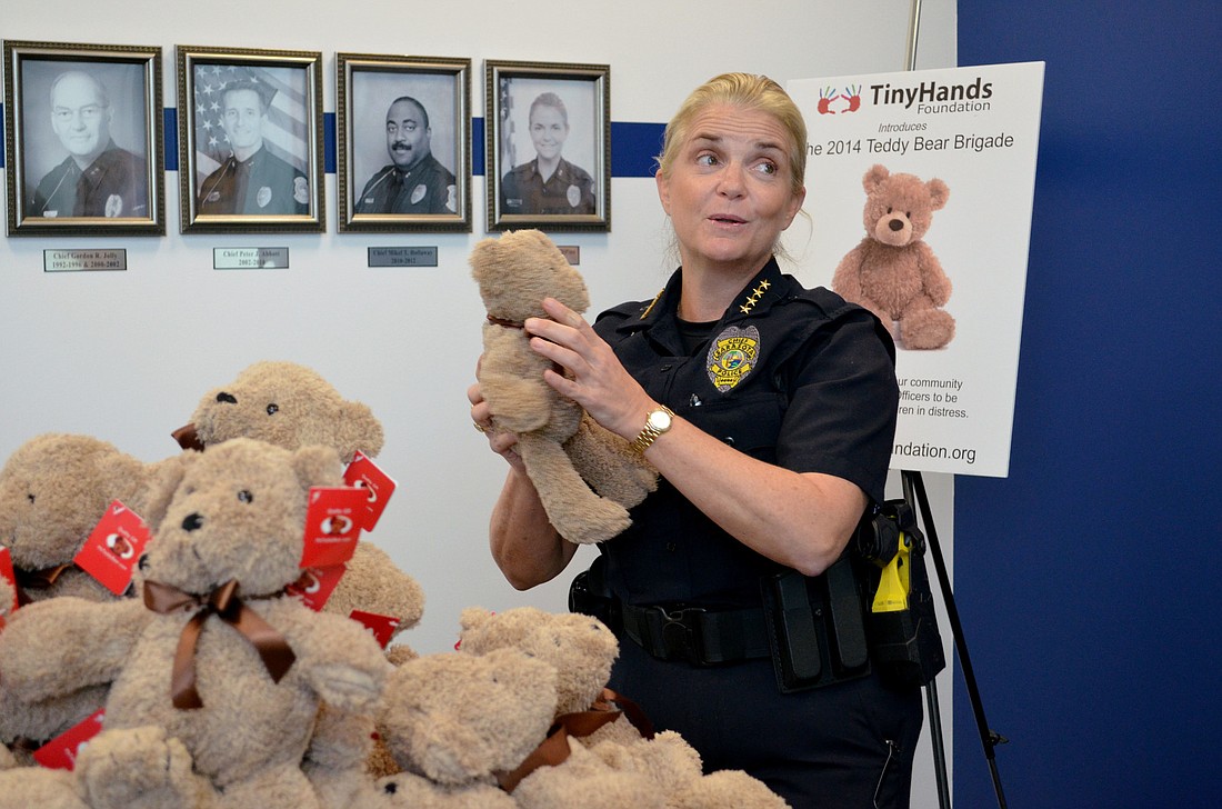 Chief DiPino picks out a teddy bear to ride along in her patrol car.
